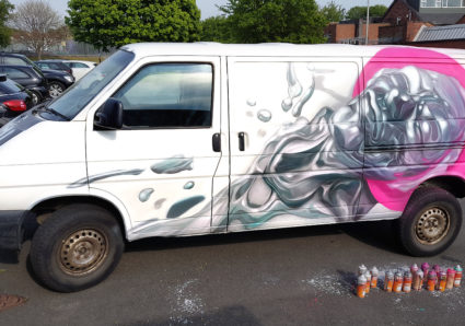 REPLETE with his latest Neon Classical piece painted on a  van